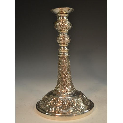 916 - Two Chinese silver candlesticks, each chased with ferocious dragons chasing flaming pearls, detachab... 