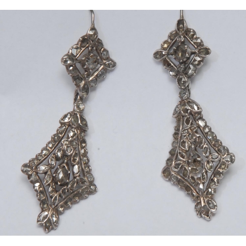 966 - A pair of renaissance revival diamond pendant earrings, each with double diamond droplet bodies, enc... 