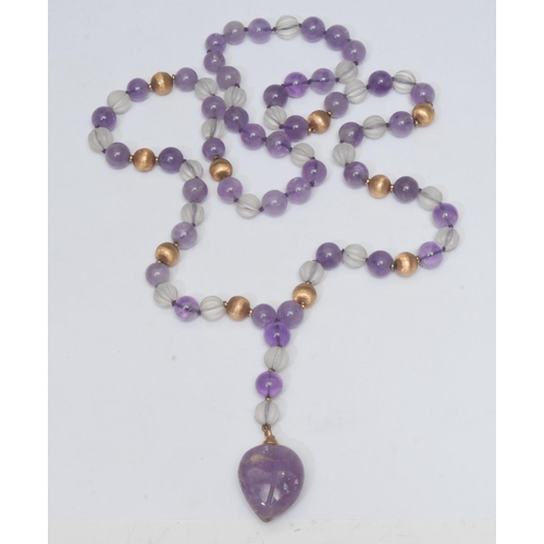 984 - An amethyst, rock crystal and gilt metal bead pendant necklace, amethyst heart drop suspended from u... 