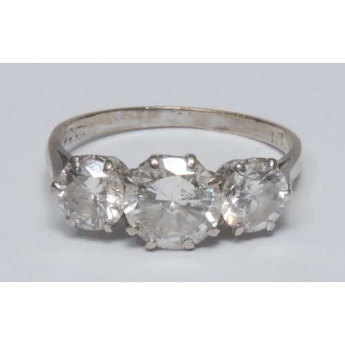 985 - A diamond trilogy ring, large central round brilliant cut diamond approx 1.50ct, flanked by a confor... 