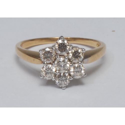 993 - A diamond flowerhead star cluster ring, central raised round brilliant cut diamond, surrounded by a ... 