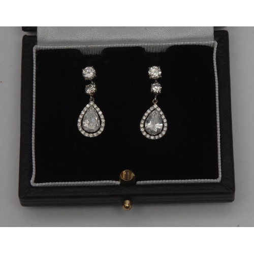 998 - A pair of diamond drop earrings, principle pear drop diamond surrounded by a collar of twenty round ... 