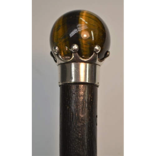 1174 - A 19th century tiger's eye and silver coloured metal mounted gentleman's walking cane, claw-set glob... 