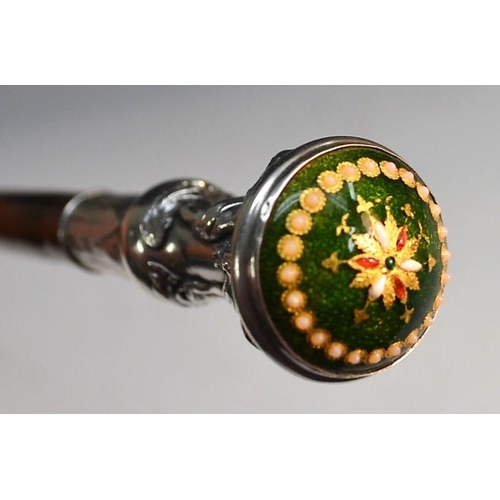 1211 - A French Belle Épqoue lady's silver, enamel and bamboo walking cane, cast alto-relievo with a frieze... 