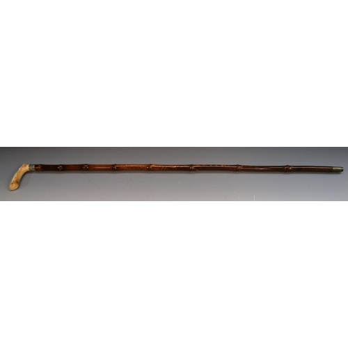 1214 - A late 19th century German gentleman's silver-mounted ivory and bamboo walking stick, the handle car... 