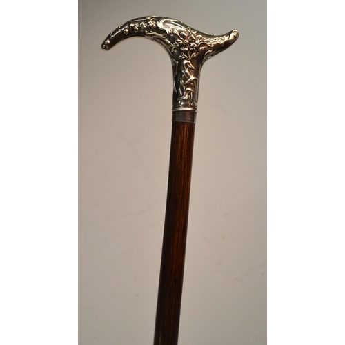 1215 - A French Art Nouveau lady's silver and hardwood walking cane, the cartouche-shaped handle chased wit... 