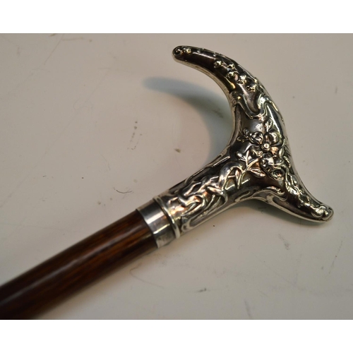 1215 - A French Art Nouveau lady's silver and hardwood walking cane, the cartouche-shaped handle chased wit... 