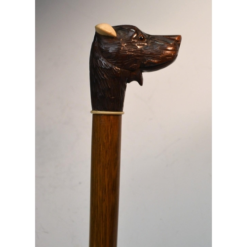 1216 - A Black Forest novelty automaton walking stick, the handle carved as the head of a dog, his mouth mo... 