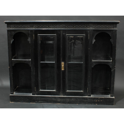 1604 - An aesthetic period ebonised bookcase/side cabinet, moulded top above a deep frieze of blind fretwor... 