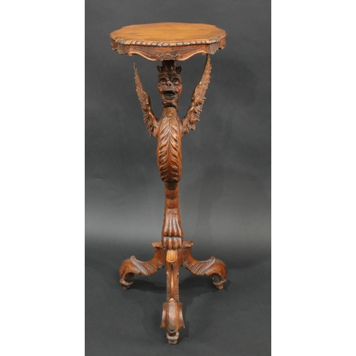 2063 - A Venetian limewood tripod torchere, boldly carved as a dragon monopodia, shaped serpentine plateau,... 