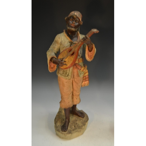 243 - A pair of 19th century Austrian terracotta figures, of Nubian musicians, bronzed flesh, their native... 