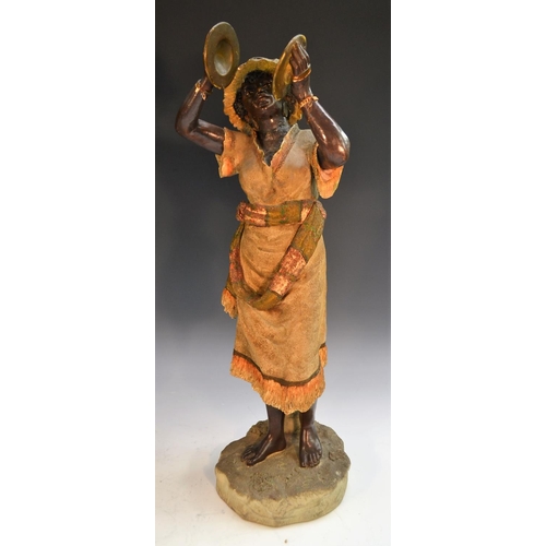 243 - A pair of 19th century Austrian terracotta figures, of Nubian musicians, bronzed flesh, their native... 