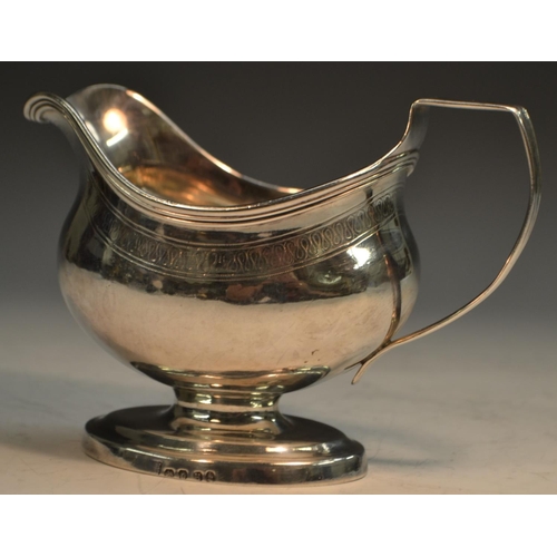 687 - A George III silver boat shaped pedestal cream jug, of good gauge, angular scroll handle, reeded rim... 