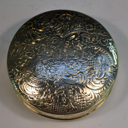 733 - A large early Victorian silver circular table snuff box, engraved overall with flowers and scrolling... 