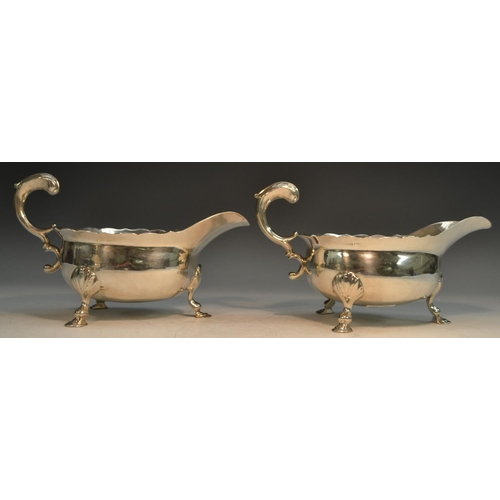 764 - A pair of large George II silver sauce boats, acanthus-capped flying scroll handles, shaped borders,... 