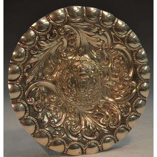 774 - A Portuguese silver coloured metal circular dish, chased with flowers and scrolling foliage, the rai... 