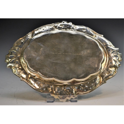 804 - A Victorian Rococo Revival silver shaped oval dish, cast with a border of basket-weave and flowering... 