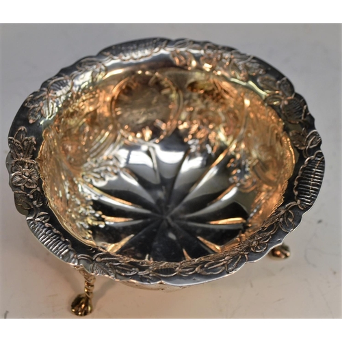 818 - A Victorian silver shaped circular bowl, of 18th century Irish design, spirally fluted and chased wi... 