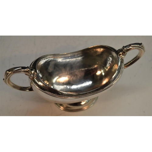 910 - Omar Ramsden - an Arts and Crafts silver boat shaped pedestal sugar basin, domed foot, scroll handle... 