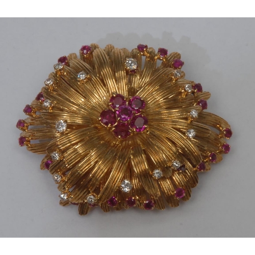 999 - A ruby and diamond flower head pendant brooch, arched double layer floral body inset with a central ... 