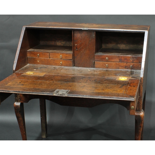 1372 - A George II oak bureau, the fall front with fitted interior, over one long drawer, cabriole  foreleg... 