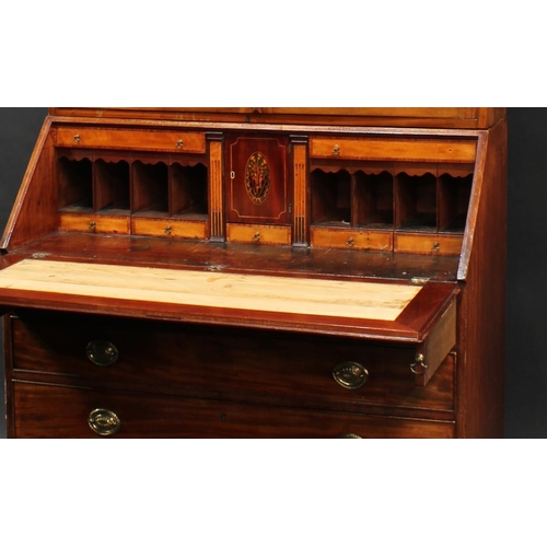 2067 - A George III mahogany bureau bookcase, stepped cornice above a pair of astragal glazed doors, fall f... 