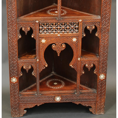 1641 - A Moorish hardwood and marquetry open corner vitrine, shallow cornice above an arrangement of mirhab... 