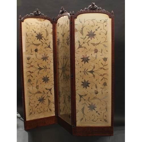 1280 - A late Victorian walnut three-fold dressing screen, each arched panel with cresting carved with flow... 