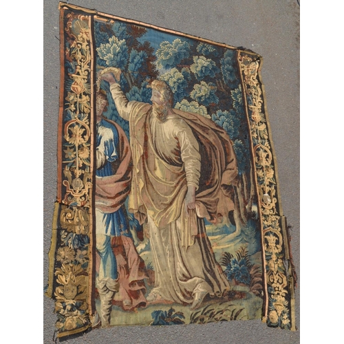 1288 - A 17th century French tapestry, the centre worked with a figure from classical antiquity, he bears a... 