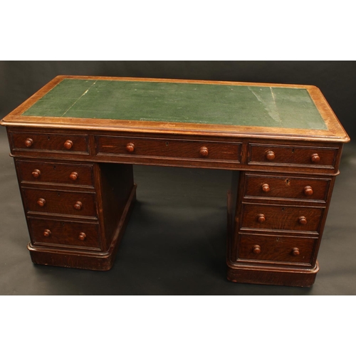 1300 - A Victorian oak twin pedestal desk, moulded rectangular top with inset writing surface above three f... 