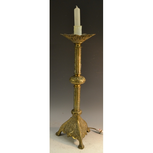 1570 - A Gothic Revival brass table lamp, the knopped pillar chased with Maltese crosses, triform base, lio... 