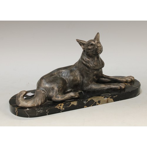 65 - An Art Deco spelter model of a reclining Alsatian dog, marble base, marked France, Carvin etched in ... 