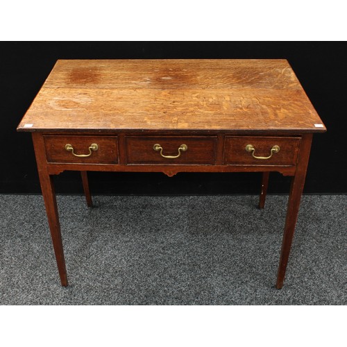 73 - A George III oak lowboy, oversailing rectangular top above three frieze drawers, brass swan neck han... 