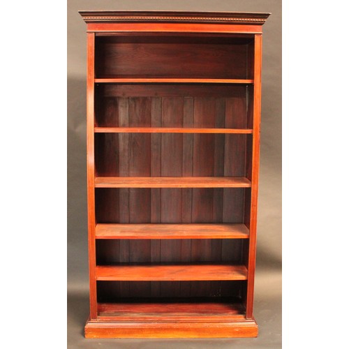 87 - A 'Edwardian' walnut open bookcase, dentil cornice above adjustable shelves, plinth base, 208cm high... 