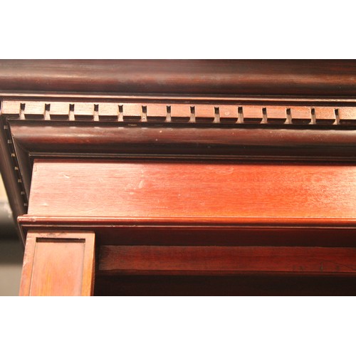 87 - A 'Edwardian' walnut open bookcase, dentil cornice above adjustable shelves, plinth base, 208cm high... 