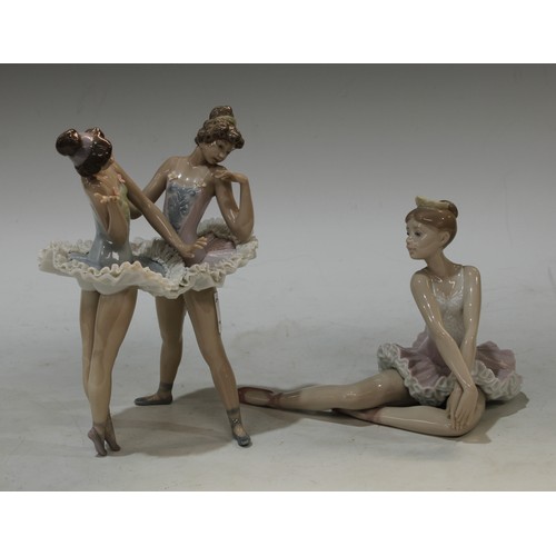 113 - A Lladro model of a ballet dancer, 13cm high; another a pair of ballet dancers, 20cm high, printed m... 