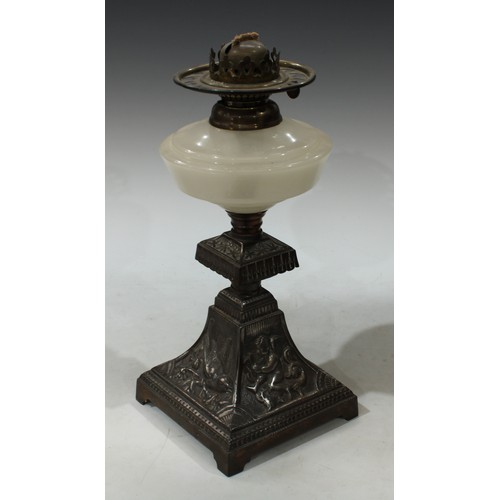 144 - A Victorian Aesthetic movement cast iron and milt glass paraffin oil lamp, the base cast with lion r... 