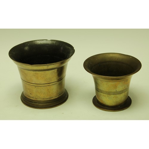 146 - An 18th century bronze mortar, of typical form, 14cm diam, c. 1750; another, similar, (2)