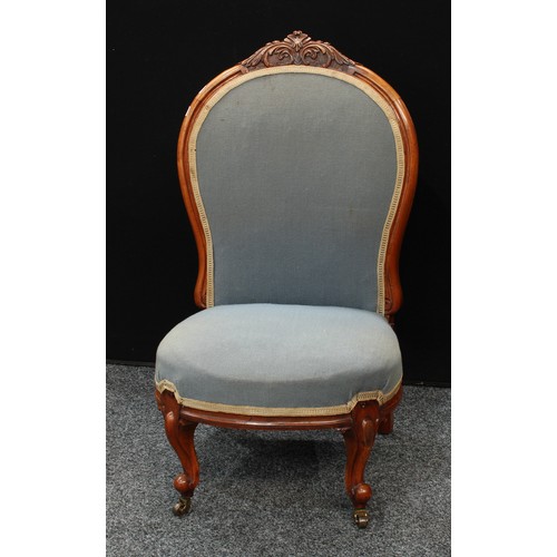 153 - A Victorian Walnut nursing chair, stuffed over upholstery,brass casters. 90cm high