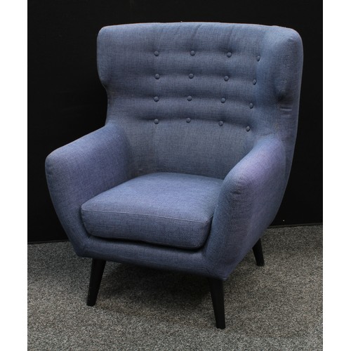 157 - A retro style wingback armchair, shallow button back, tapered cylindrical legs, 104.5cm high