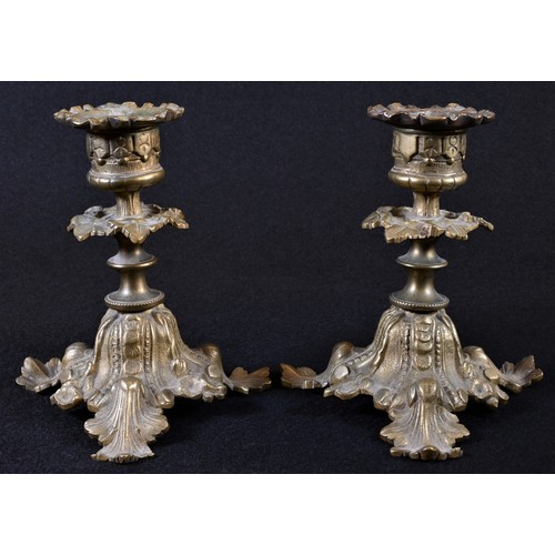 5204 - A pair of 19th century gilt bronze candlesticks, detachable sconces, triform bases, cast throughout ... 