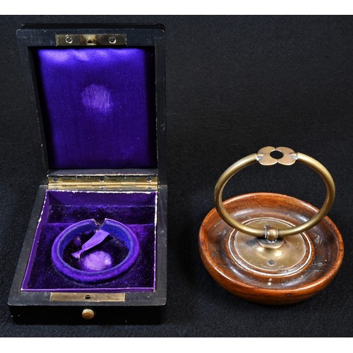 5337 - An early 20th century German patent pocket watch stand, the timepiece held within a sprung hoop, dis... 