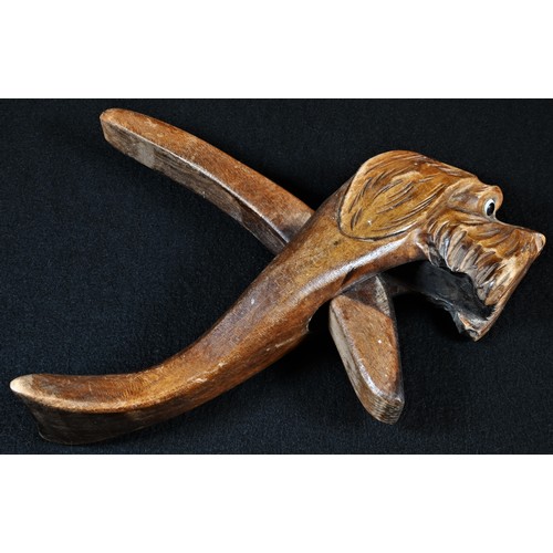 5082 - A Black Forest novelty lever-action nutcracker, as the head of a dog, glass eyes, 22cm long