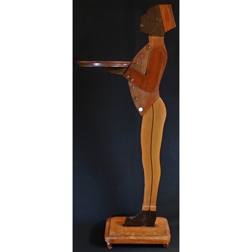 5311 - An Art Deco period novelty 'blackamoor' waiter, as a Moorish attendant, he stands, in livery, proffe... 