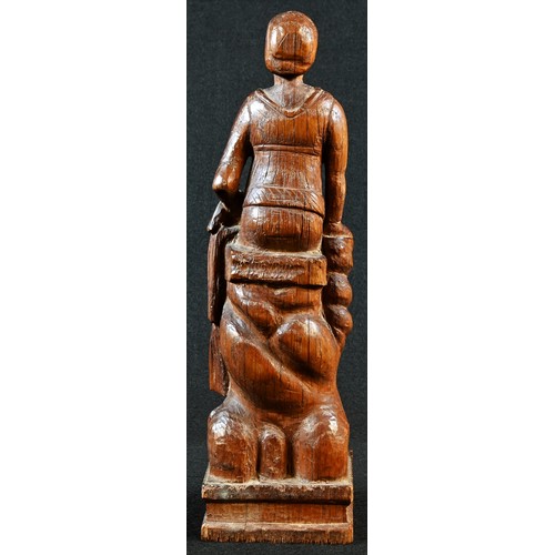 5195 - A North European oak carving, of a lady, seated upon rocks, 25.5cm high, 19th century