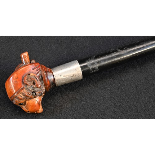 5345 - An early 20th century novelty coquilla nut automaton walking stick, the pommel carved as a comical m... 