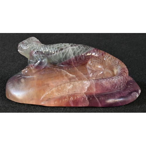 5304 - An amethyst quartz desk weight, carved as a lizard, 10cm wide