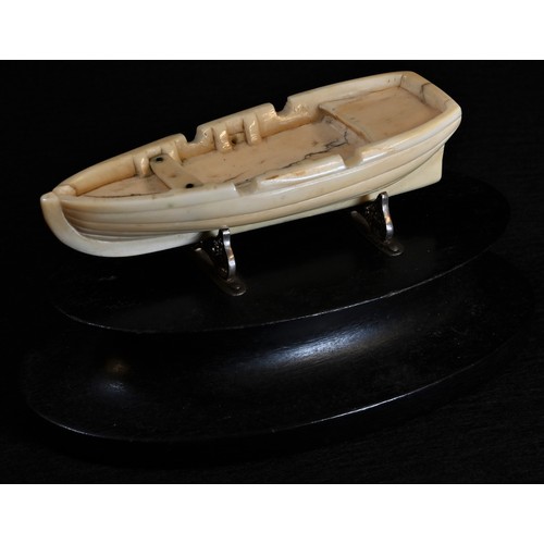 5447 - Marine Folk Art - an early 19th century whale tooth carving, of an open boat, 8.5cm long