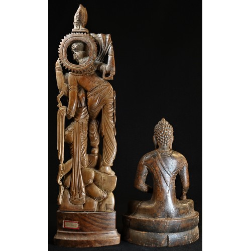 5377 - An Indian sandalwood carving, of deities, 36cm high; an Indian/Burmese hardwood carving, of Buddha, ... 