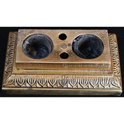 5243 - A post-Regency gilt bronze desk stand, the cover surmounted by a dog and enclosing pen holders and a... 